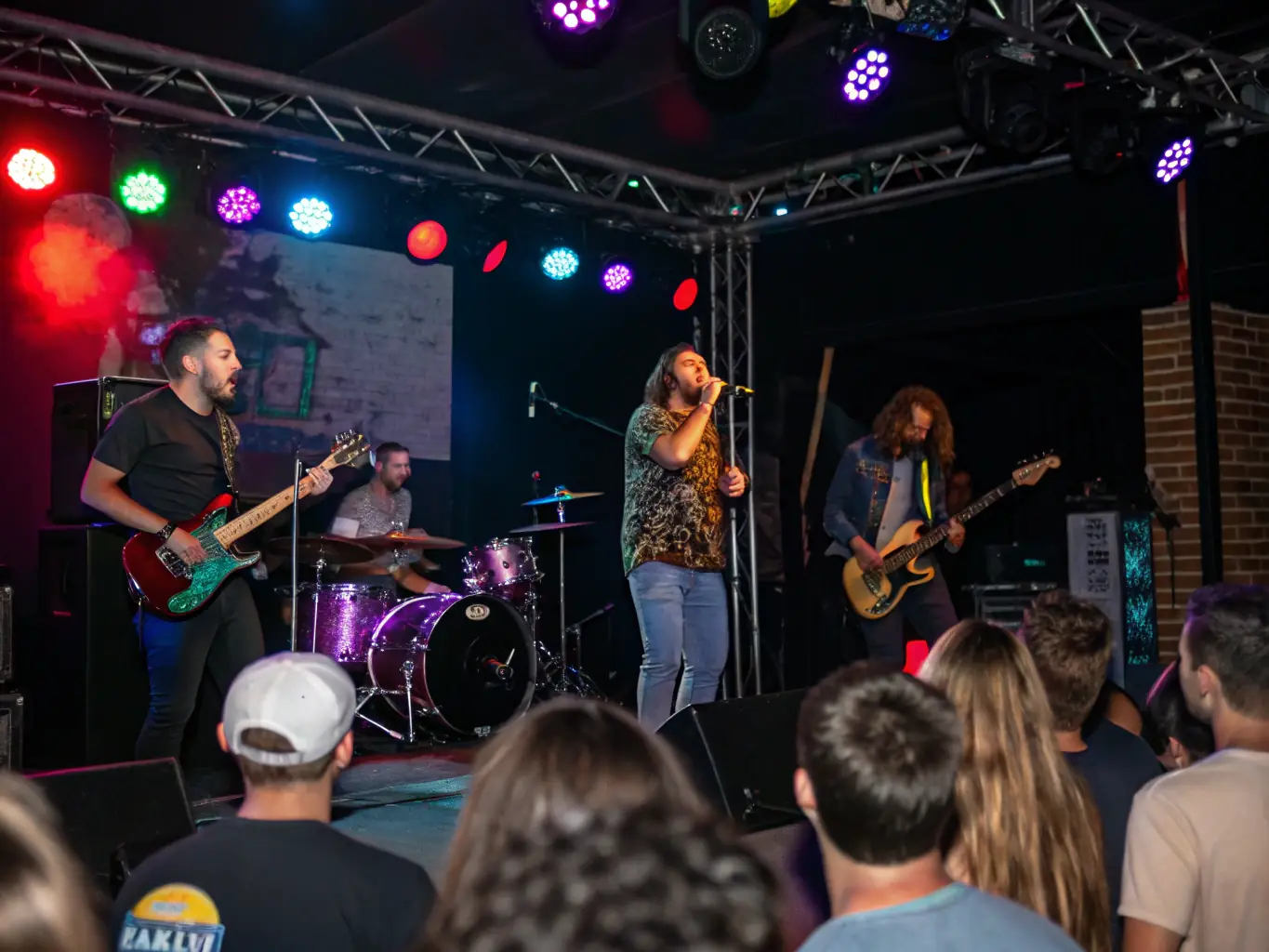 A dynamic image of a live performance event organized by L'ANODINE, featuring musicians and a diverse audience, capturing the energy and excitement of the event.